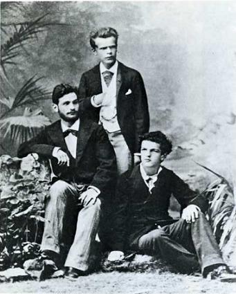 Władysław Pachulski (standing), pictured in 1882 with Petr Danil'chenko and Claude Debussy (seated)